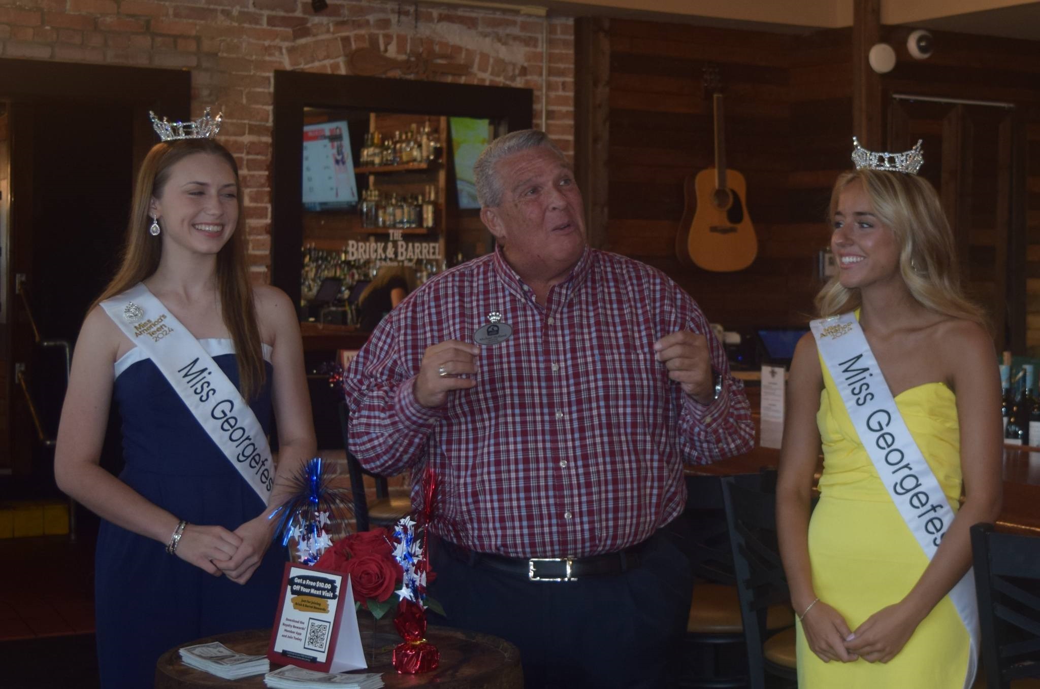 Mayor Michael Holland introducing Miss Teen Georgefest Chloie Sebree and Miss Georgefest Caroline Schapansky