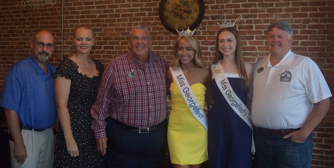 City Manager Tom Carrino, Events and Tourism Manager Miranda Muir, Mayor Michael Holland, Miss Georgefest Caroline Schapansky, Miss Teen Georgefest Chloie Sebree and City Commissioner Gary Ashcraft